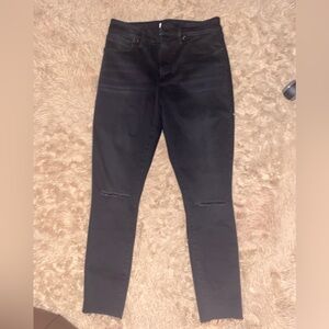 Good American double looped black high waisted jeans with mid knee split;distres